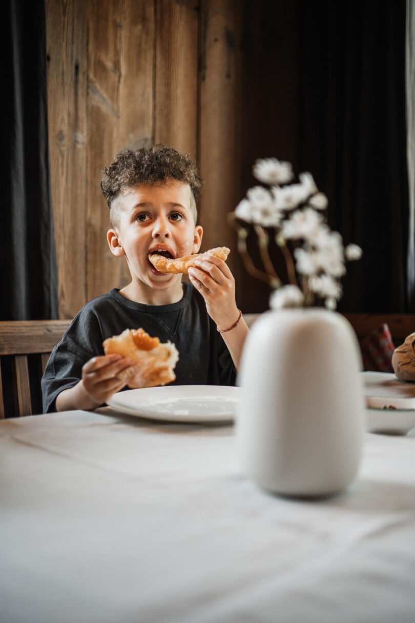 Junge beim Krapfen essen