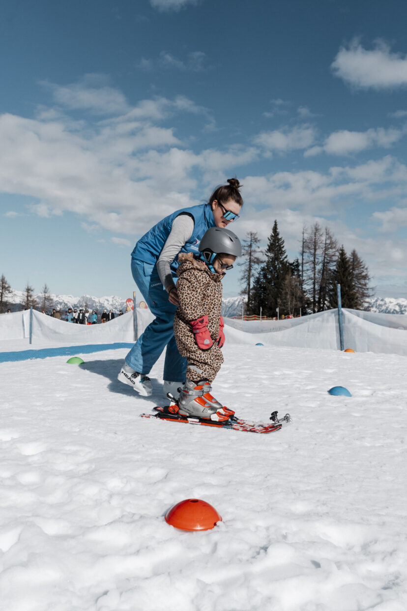 Kind in der Skischule mit Skilehrerin im Snow Space Salzburg